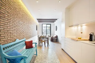 a room with a blue bench next to a brick wall at Sweet Home Sitges BY BLAUSITGES in Sitges