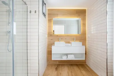 a bathroom with two sinks and a shower at Sweet Home Sitges BY BLAUSITGES in Sitges