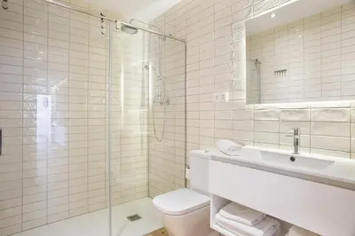 a bathroom with a toilet and a sink and a shower at Sweet Home Sitges BY BLAUSITGES in Sitges