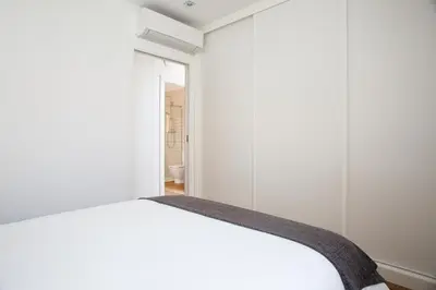 a bedroom with a white bed in a room at Sweet Home Sitges BY BLAUSITGES in Sitges