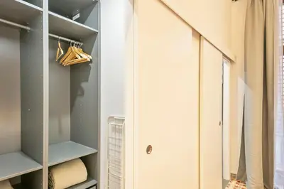 a closet with white walls and a mirror at Citytrip Palau de la Música in Barcelona
