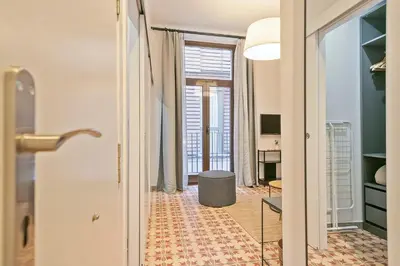 a hallway with a room with a table and a desk at Citytrip Palau de la Música in Barcelona