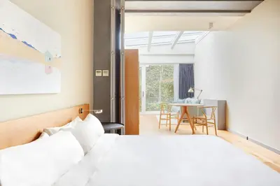 a bedroom with a white bed and a table at Le Palacete by Sweett in Barcelona