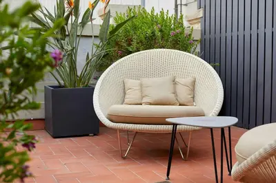 a white chair with a pillow on a patio at Le Palacete by Sweett in Barcelona