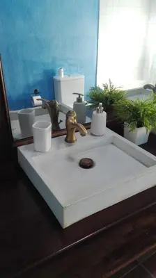a bathroom sink with two cups and a faucet at El Terral in Sant Vicenç de Montalt