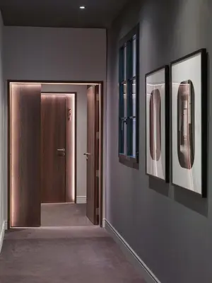 a hallway with three pictures on the wall and a door at H10 Casa Mimosa 4* Sup in Barcelona