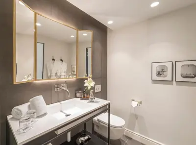 a bathroom with a sink and a toilet and a mirror at H10 Casa Mimosa 4* Sup in Barcelona