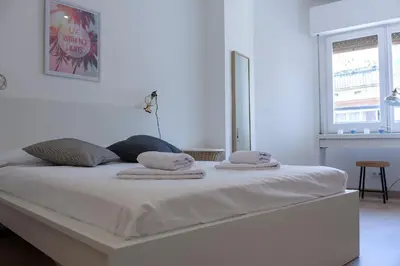 a white bed with towels on it in a room at Flateli Roger 6 in Barcelona