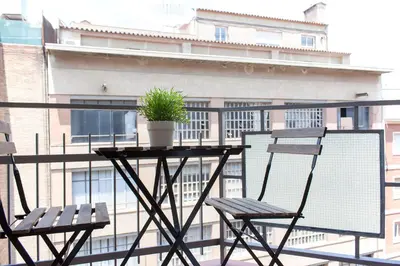 two chairs and a plant on a table on a balcony at Flateli Roger 6 in Barcelona