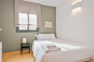 a bedroom with a white bed and a window at Inside Barcelona Apartments Princep in Barcelona