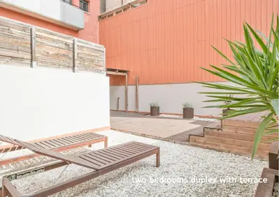 a bench sitting on the side of a building at Inside Barcelona Apartments Princep in Barcelona