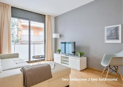 a living room with a couch and a tv at Inside Barcelona Apartments Princep in Barcelona