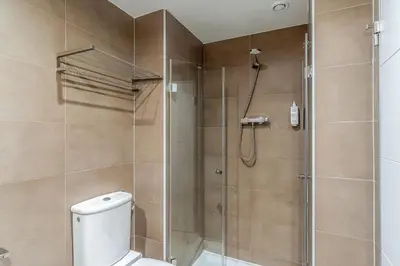 a bathroom with a shower stall and a toilet at AB Sagrada Familia - Gaudí in Barcelona