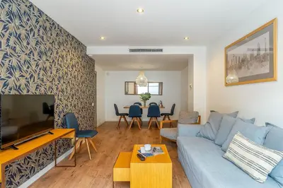 a living room with a blue couch and a table at AB Sagrada Familia - Gaudí in Barcelona