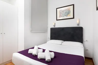 a bedroom with a large bed with towels on it at Mayerling Schumann Barcelona in Barcelona