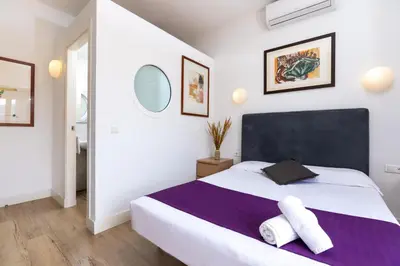 a bedroom with a large bed with two towels on it at Mayerling Bisbe Urquinaona in Barcelona