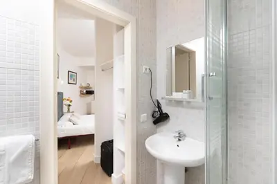 a bathroom with a sink and a glass shower at Mayerling Bisbe Urquinaona in Barcelona