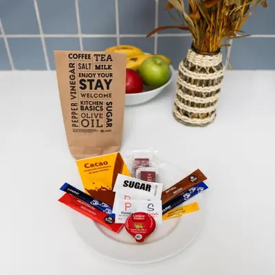 a white counter top with a bowl of toothbrushes and a bag of sugar at Mayerling Bisbe Urquinaona in Barcelona