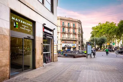 a street in a city with people walking on the sidewalk at Mayerling Bisbe Urquinaona in Barcelona