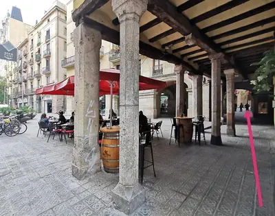 a building with tables and chairs and a barrel at Classbedroom Born Apartments in Barcelona
