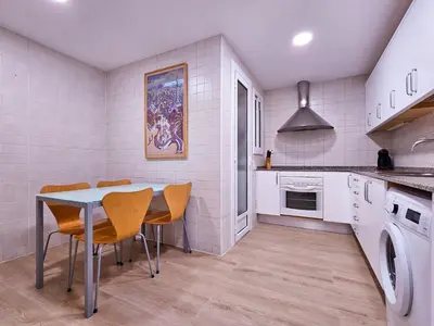 a kitchen with a table and chairs in it at Classbedroom Park Güell Apartment in Barcelona