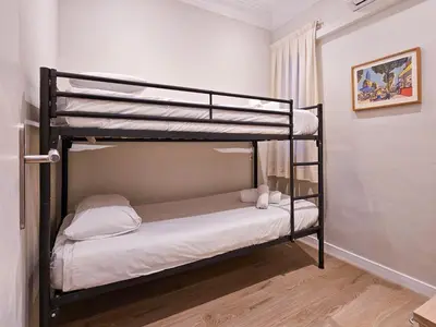 a bedroom with two bunk beds in a room at Classbedroom Park Güell Apartment in Barcelona