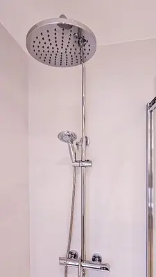 a bathroom with a shower with a light on the ceiling at Classbedroom Park Güell Apartment in Barcelona