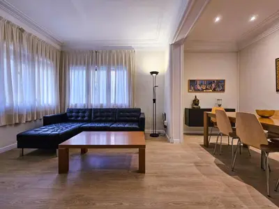 a living room with a couch and a table at Classbedroom Park Güell Apartment in Barcelona