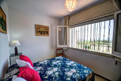 a bedroom with a bed and a large window at Can Ferran by Hello Homes Sitges in Sitges