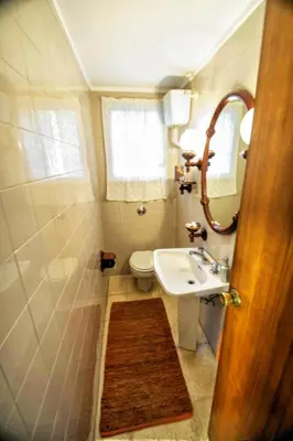 a bathroom with a sink and a toilet and a mirror at Can Ferran by Hello Homes Sitges in Sitges