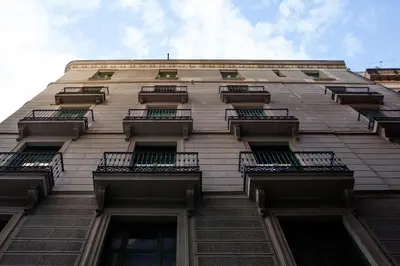 a tall building with balconies on the side of it at Ramblas Apartments in Barcelona