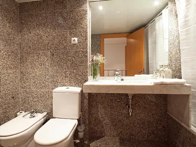 a bathroom with a toilet and a sink and a mirror at Apartment Barcelona Rentals - Park Güell Apartments in Barcelona