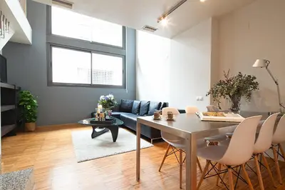 a living room with a table and a couch at Apartment Barcelona Rentals - Park Güell Apartments in Barcelona