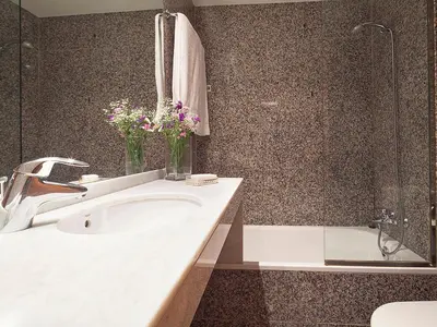 a bathroom with a sink and a shower with flowers at Apartment Barcelona Rentals - Park Güell Apartments in Barcelona