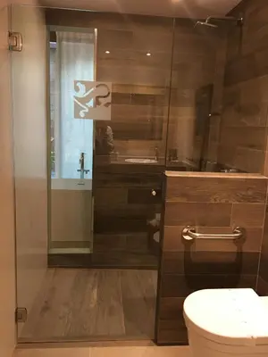 a bathroom with a toilet and a glass shower at Hotel Calabria in La Garriga