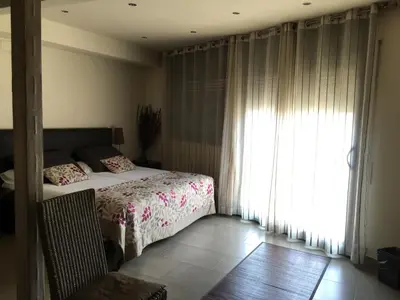 a bedroom with a bed and a large window at Hotel Calabria in La Garriga