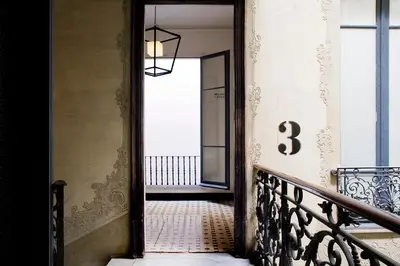 a hallway with a staircase with a door and a window at Praktik Rambla in Barcelona