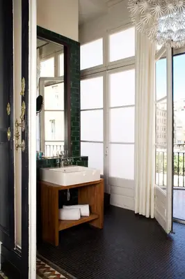 a bathroom with a sink and a large mirror at Praktik Rambla in Barcelona