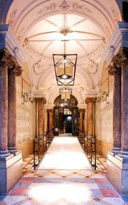 an empty hallway in a building with a chandelier at Praktik Rambla in Barcelona