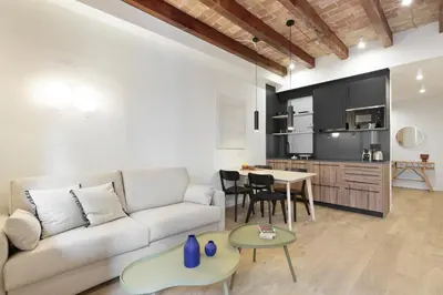 a living room with a couch and a table at Diagonal Apartments by Olala Homes in Barcelona