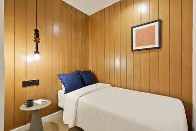 a bedroom with a bed and a table with a side table at Diagonal Apartments by Olala Homes in Barcelona