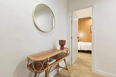a mirror on a wall in a room with a table at Diagonal Apartments by Olala Homes in Barcelona
