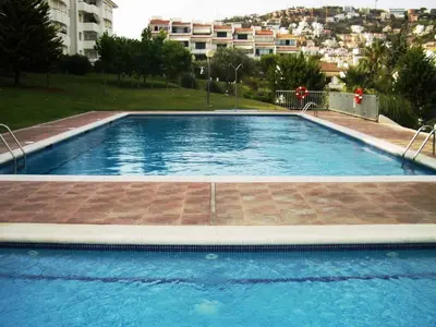 a large swimming pool in the middle of a building at Sitges Beach Loft in Sitges