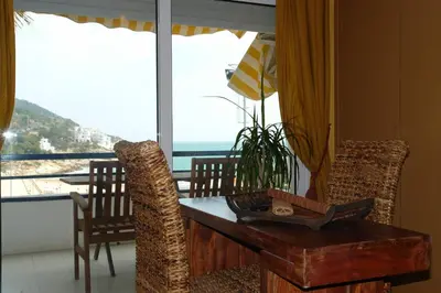 a dining room with a table and a view of the ocean at Sitges Beach Loft in Sitges