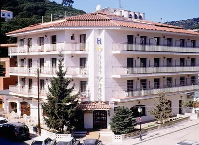 a large white building with cars parked in front of it at Raco d'en Pepe in Calella