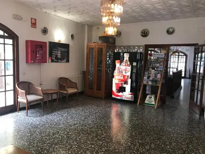 a room with a store with a refrigerator and chairs at Raco d'en Pepe in Calella