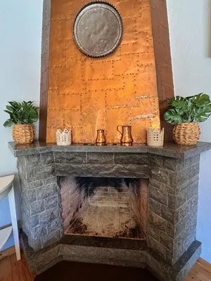 a stone fireplace with two plants on top of it at Finca La Pedrera in Capellades