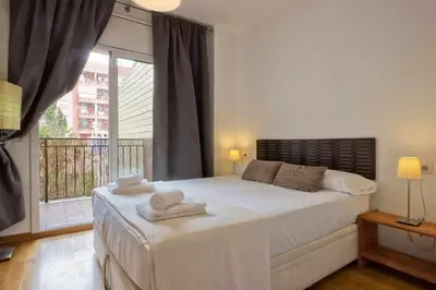 a bedroom with a large bed with towels on it at Comfortable 4 rooms 2Bath w balcony in Barcelona