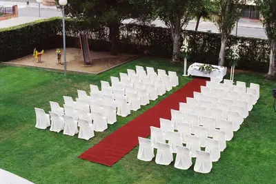 a bunch of white chairs and a red and white carpet at Hotel Granollers in Granollers
