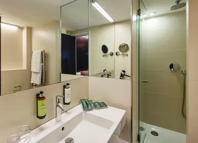a bathroom with a sink and a shower at Sercotel Hotel Rosellon in Barcelona